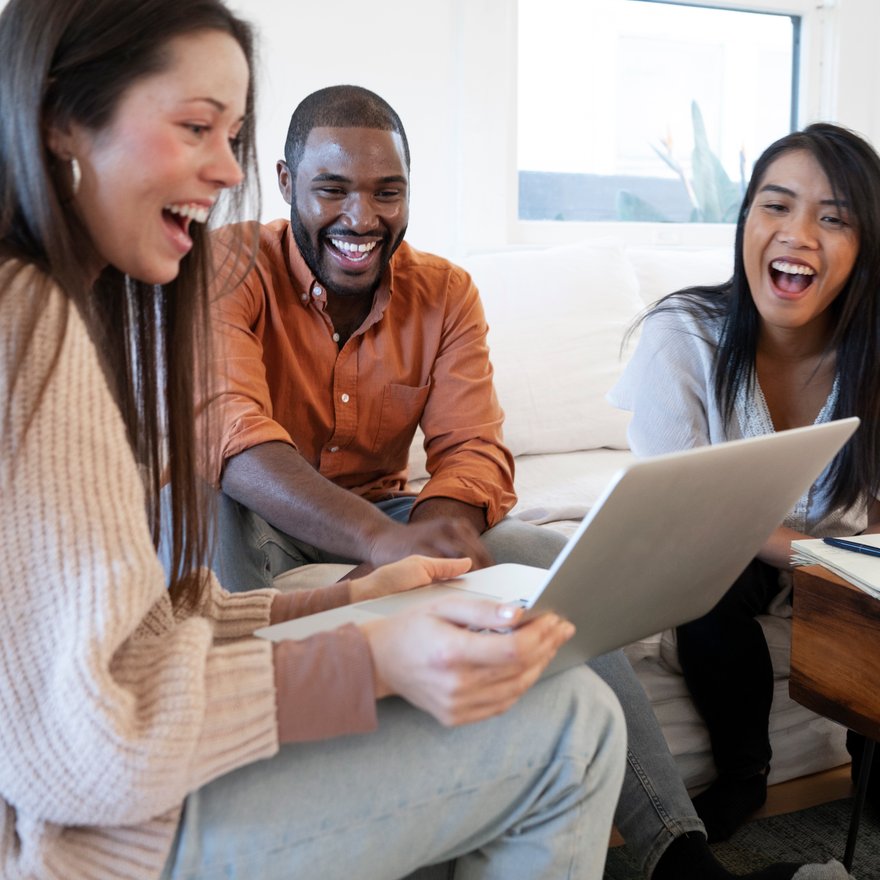 People meeting and smiling in a small conference setting