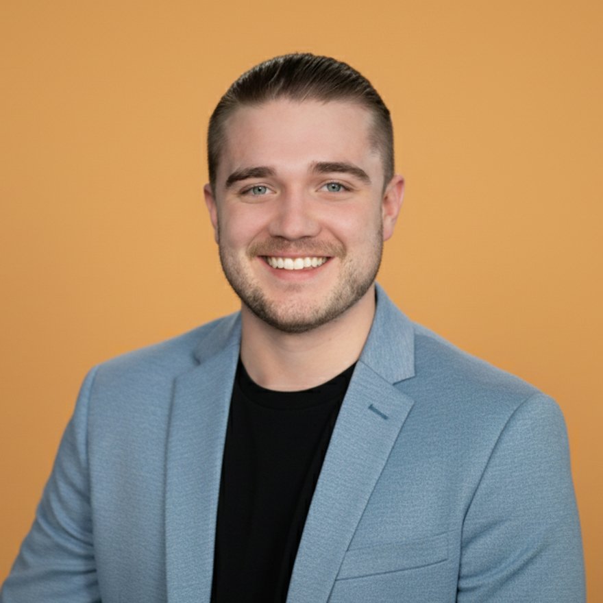 Jacob Weidokal, owner and developer at Cuyahoga Digital, wearing a black tee with blue blazor and a purple background.